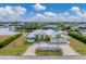 Aerial view of waterfront home with canal access, lush landscaping, and a large backyard at 15228 Chinook Way, Port Charlotte, FL 33981