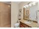 Bathroom with shower, granite vanity, and updated fixtures at 15228 Chinook Way, Port Charlotte, FL 33981