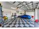 Garage with checkered floor, plenty of storage, and high ceilings at 15228 Chinook Way, Port Charlotte, FL 33981