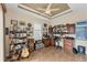 Home office with built-in shelving, a desk, and musical instruments at 15228 Chinook Way, Port Charlotte, FL 33981