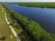 Aerial view of a waterfront pathway with a person jogging along the water at 15228 Chinook Way, Port Charlotte, FL 33981