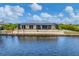 Waterfront home showcasing a large backyard and screened-in patio at 15228 Chinook Way, Port Charlotte, FL 33981