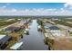 Aerial view showcasing a canal-front property with a large backyard at 15626 Meacham Cir, Port Charlotte, FL 33981
