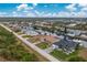Aerial perspective of a canal-front property with neighboring houses at 15626 Meacham Cir, Port Charlotte, FL 33981