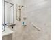 Well-lit walk-in shower with grab bar and tiled walls at 15626 Meacham Cir, Port Charlotte, FL 33981