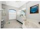 Elegant bathroom with double vanity, large soaking tub, and separate shower at 15626 Meacham Cir, Port Charlotte, FL 33981