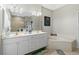Bathroom with double vanity, corner tub, and updated finishes at 15626 Meacham Cir, Port Charlotte, FL 33981
