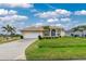 Single story home with attached garage and lush lawn at 15626 Meacham Cir, Port Charlotte, FL 33981