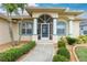 Well-maintained home with attractive landscaping and a screened-in entryway at 15626 Meacham Cir, Port Charlotte, FL 33981