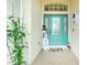 Inviting teal front door featuring decorative glass and seasonal decor at 15626 Meacham Cir, Port Charlotte, FL 33981