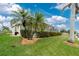 Landscaped yard with tropical plants and canal views at 15626 Meacham Cir, Port Charlotte, FL 33981