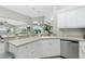 Bright kitchen with stainless steel appliances and white cabinetry at 15626 Meacham Cir, Port Charlotte, FL 33981