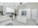 Kitchen boasts an island, stainless steel appliances, and white cabinets at 15626 Meacham Cir, Port Charlotte, FL 33981