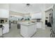 Bright kitchen with white cabinetry, an island, and views to the Gathering room at 15626 Meacham Cir, Port Charlotte, FL 33981