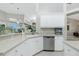 Kitchen features a corner sink, white cabinets, and stainless steel appliances at 15626 Meacham Cir, Port Charlotte, FL 33981