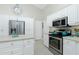 Spacious kitchen, featuring stainless steel appliances and an island at 15626 Meacham Cir, Port Charlotte, FL 33981