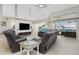 Spacious living room featuring a fireplace and comfortable leather seating at 15626 Meacham Cir, Port Charlotte, FL 33981