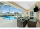 Inviting screened-in pool area with patio furniture and fire pit at 15626 Meacham Cir, Port Charlotte, FL 33981