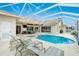 Relaxing pool area with a covered lanai and lounge chairs at 15626 Meacham Cir, Port Charlotte, FL 33981