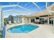 Inviting screened pool and spa with patio furniture at 15626 Meacham Cir, Port Charlotte, FL 33981