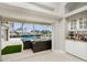 Indoor view of a pool and outdoor patio area from a wet bar at 15626 Meacham Cir, Port Charlotte, FL 33981