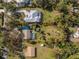 Aerial view of home with pool, surrounded by trees, in a quiet residential neighborhood at 1651 Maria St, Englewood, FL 34223