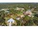 Aerial view showing a single-Gathering home with a pool and spacious lot in a residential neighborhood at 1651 Maria St, Englewood, FL 34223