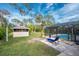 Spacious backyard with screened pool, gazebo, and lush landscaping at 1651 Maria St, Englewood, FL 34223