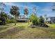 Large backyard with fire pit and home view at 1651 Maria St, Englewood, FL 34223