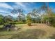 Large backyard with fire pit and woodpile at 1651 Maria St, Englewood, FL 34223