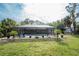 Expansive backyard with a screened-in pool and lush landscaping at 1651 Maria St, Englewood, FL 34223