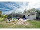 Large backyard with screened pool, patio furniture, and lush landscaping at 1651 Maria St, Englewood, FL 34223