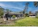 Large backyard oasis with pool, gazebo, and tropical landscaping at 1651 Maria St, Englewood, FL 34223
