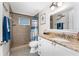 Bathroom with shower, toilet and granite countertop at 1651 Maria St, Englewood, FL 34223