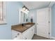 Bathroom with granite countertop and white cabinets at 1651 Maria St, Englewood, FL 34223