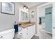 Bathroom with granite countertop and white cabinets at 1651 Maria St, Englewood, FL 34223