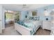 Bedroom with white wooden frame bed and pool view at 1651 Maria St, Englewood, FL 34223
