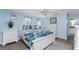 Bedroom with white furniture, light blue walls, and tile flooring at 1651 Maria St, Englewood, FL 34223