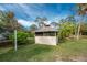 Screened gazebo with shingled roof in backyard at 1651 Maria St, Englewood, FL 34223