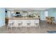Island kitchen with seating, stainless steel appliances, and view to backyard at 1651 Maria St, Englewood, FL 34223