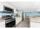 Modern kitchen with stainless steel appliances at 1651 Maria St, Englewood, FL 34223