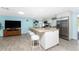 Open kitchen with island, stainless steel appliances, and white cabinetry at 1651 Maria St, Englewood, FL 34223