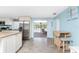 Kitchen with island, stainless steel appliances, and view to pool area at 1651 Maria St, Englewood, FL 34223