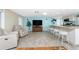Open concept kitchen with island, stainless steel appliances, and white cabinetry at 1651 Maria St, Englewood, FL 34223