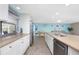 Modern kitchen with white cabinets, stainless steel appliances, and a large island at 1651 Maria St, Englewood, FL 34223