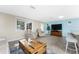 Living area with comfortable seating and large TV at 1651 Maria St, Englewood, FL 34223