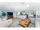 Open living room and kitchen with light tile floors at 1651 Maria St, Englewood, FL 34223