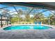 Enclosed pool and patio area with seating at 1651 Maria St, Englewood, FL 34223