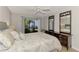 Bedroom with large dresser and access to patio at 1730 Manasota Beach Rd # 110, Englewood, FL 34223
