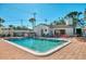 Inviting community pool with lounge chairs and patio area at 1730 Manasota Beach Rd # 110, Englewood, FL 34223